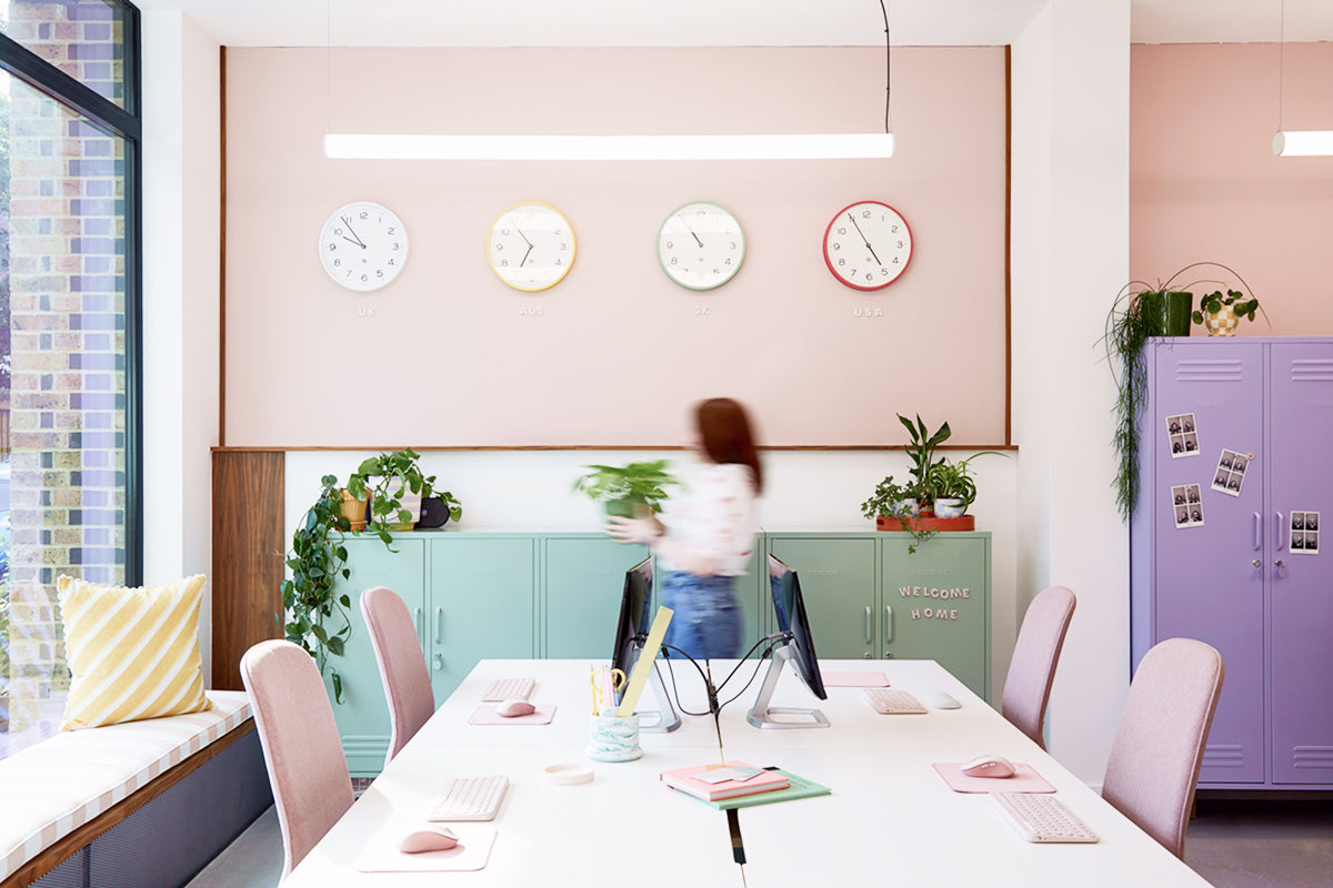 The Midi locker in Sage green and The Twinny in Lilac purple in Mustard Made's pastel UK office with wall clocks